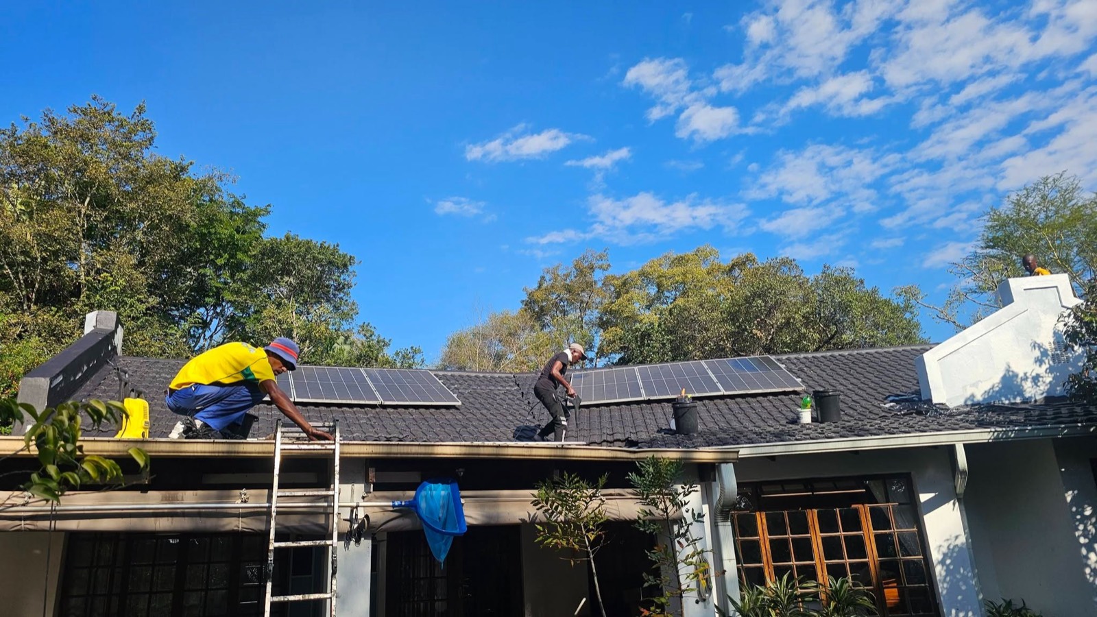 Team restoring a tiled roof with solar panels
