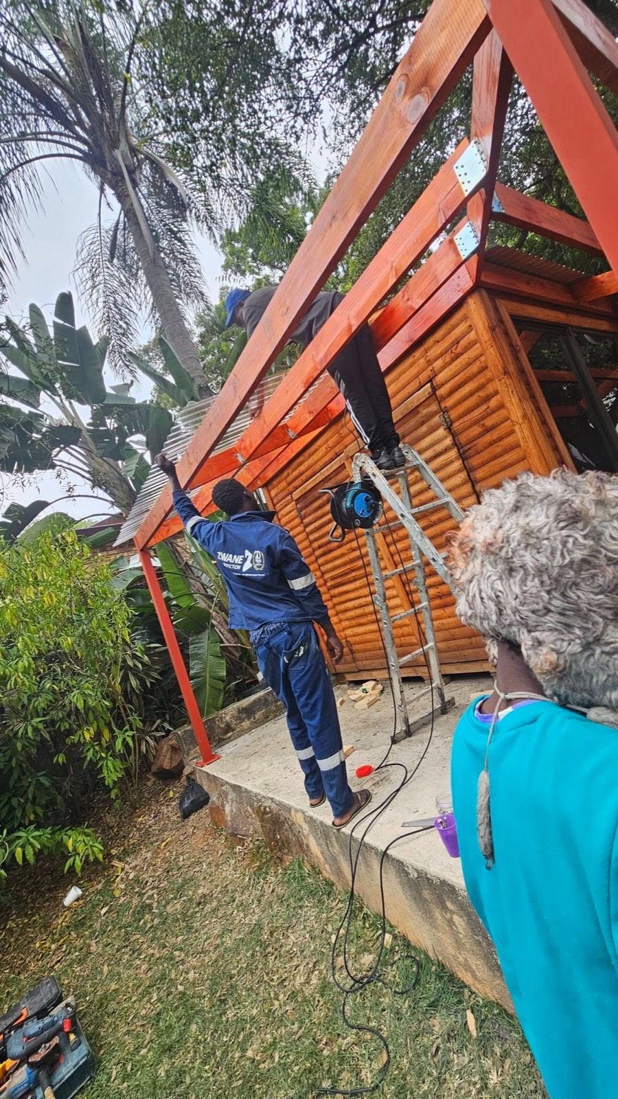 Shazam Construction team building a timber pergola roof